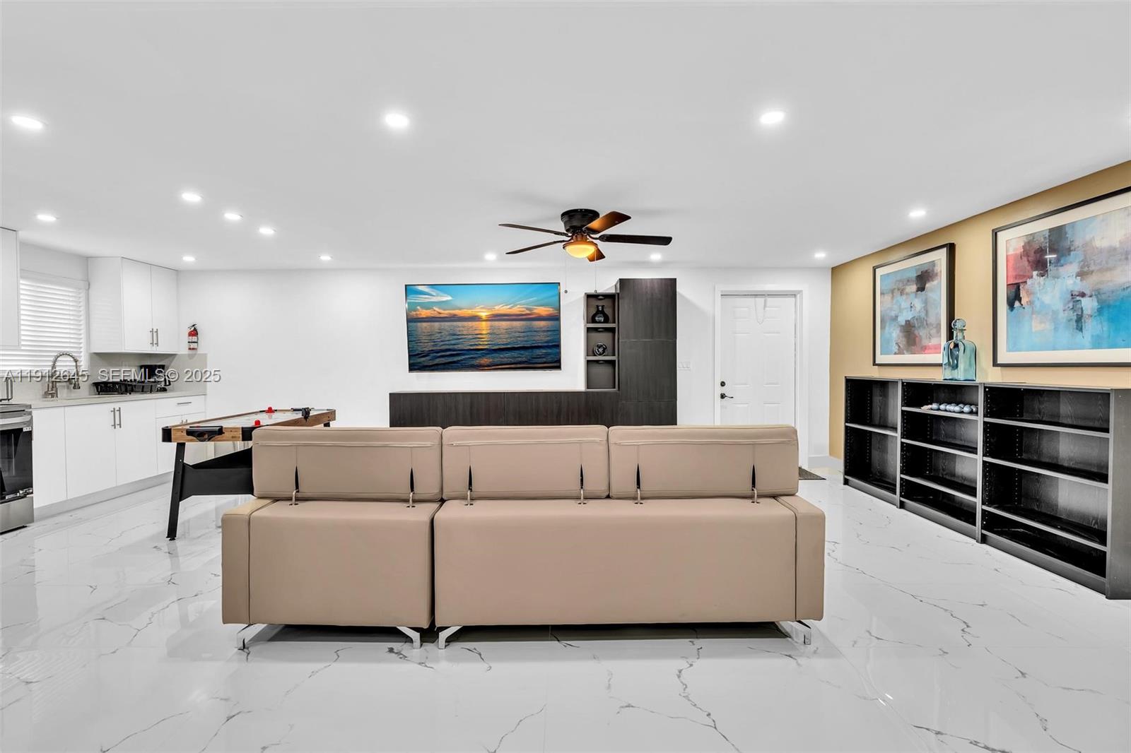 923 Northwest 110th Street, Unit A Miami, FL 33168 - Photo 5 of 21 a living room with furniture and a flat screen tv