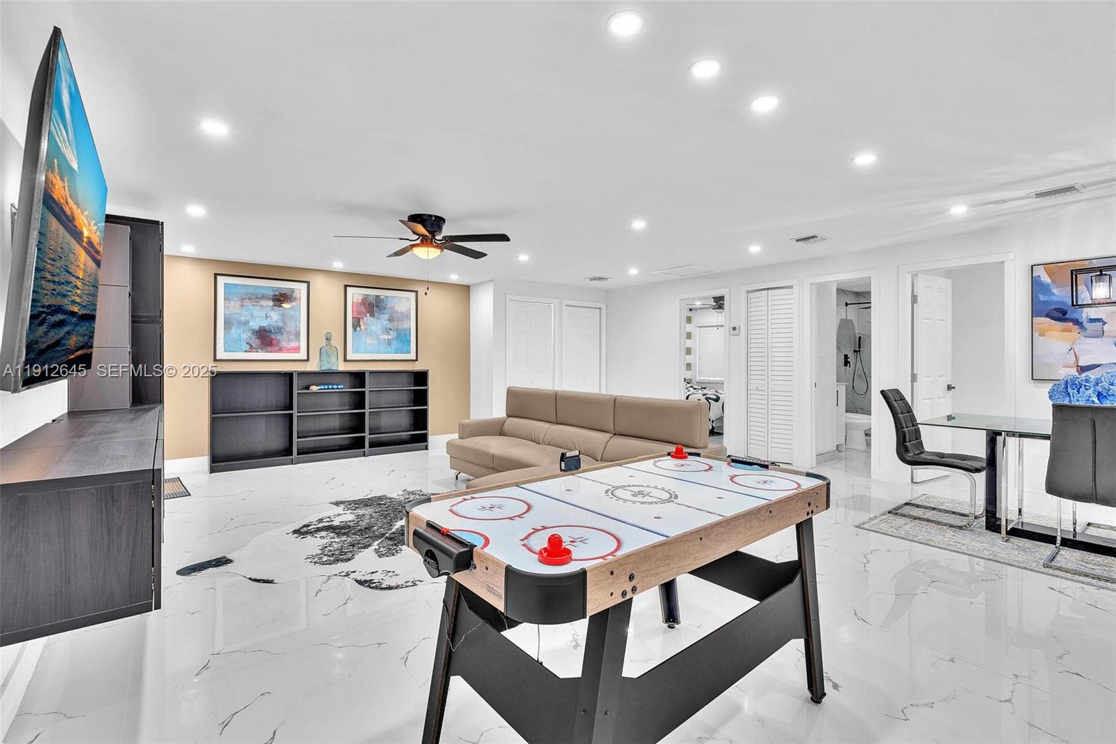 923 Northwest 110th Street, Unit A Miami, FL 33168 - Photo 8 of 21 a living room with stainless steel appliances furniture and a flat screen tv