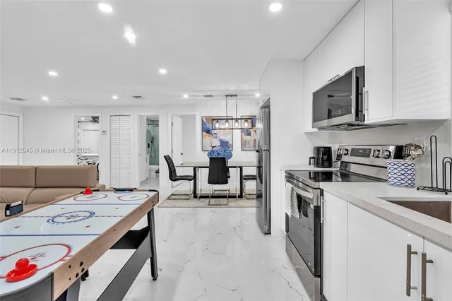 a kitchen that has a lot of counter space and stainless steel appliances