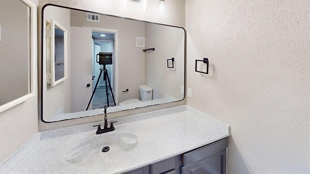 11460 Audelia Road, Unit 284 Dallas, TX 75243 - Photo 11 of 15 a bathroom with a sink and a mirror