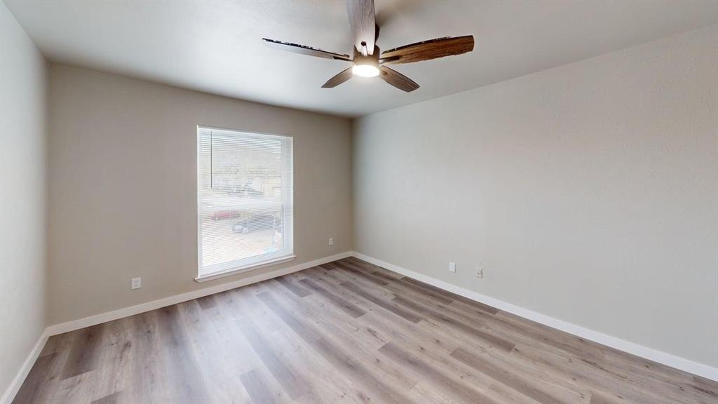 11460 Audelia Road, Unit 284 Dallas, TX 75243 - Photo 6 of 15 wooden floor in an empty room with a window