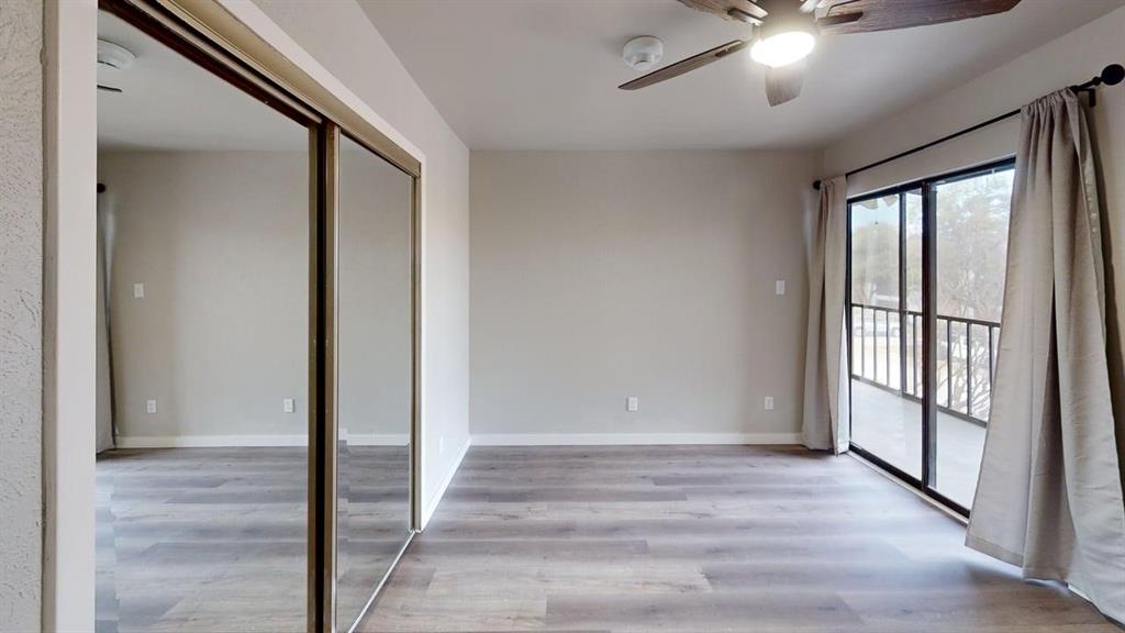 11460 Audelia Road, Unit 284 Dallas, TX 75243 - Photo 8 of 15 a view of an empty room with wooden floor and a window
