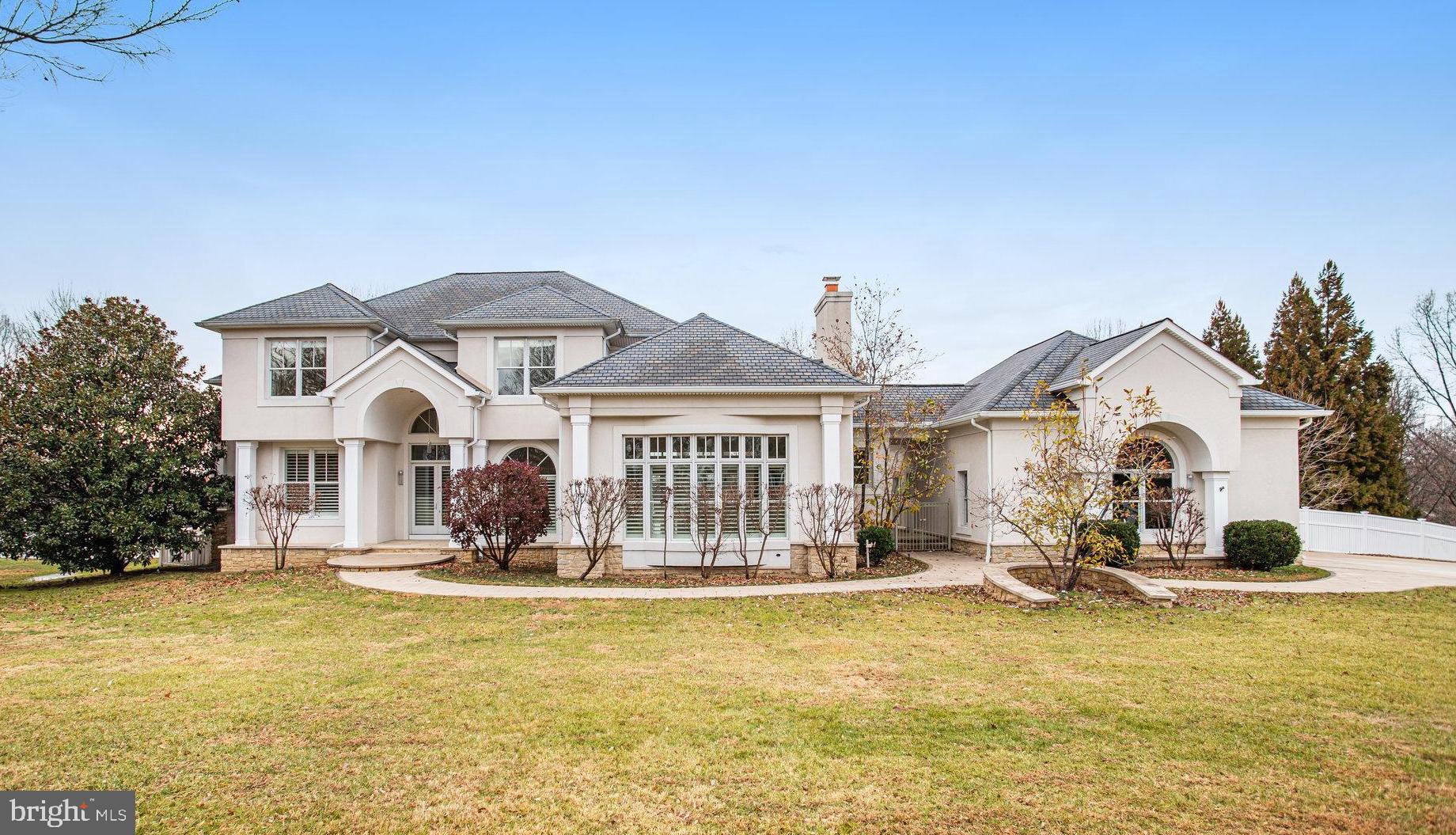 a view of a white house with swimming pool in front of it