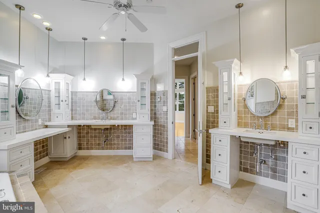 a open kitchen with cabinets a stove and a chandelier