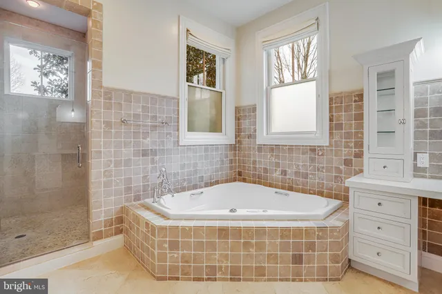 a bathroom with a tub sink and shower