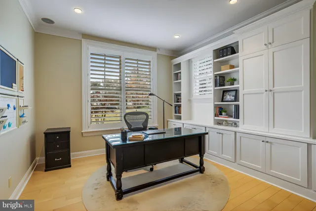 a view of a workspace with furniture and a window