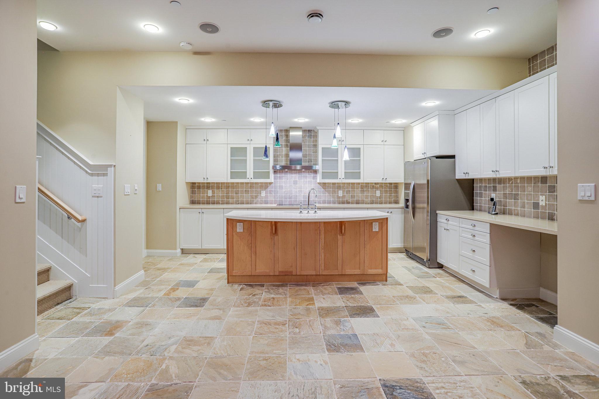 21612 Ripplemead Drive Gaithersburg, MD 20882 - Photo 25 of 39 a large kitchen with kitchen island a stove a sink a counter top space and cabinets