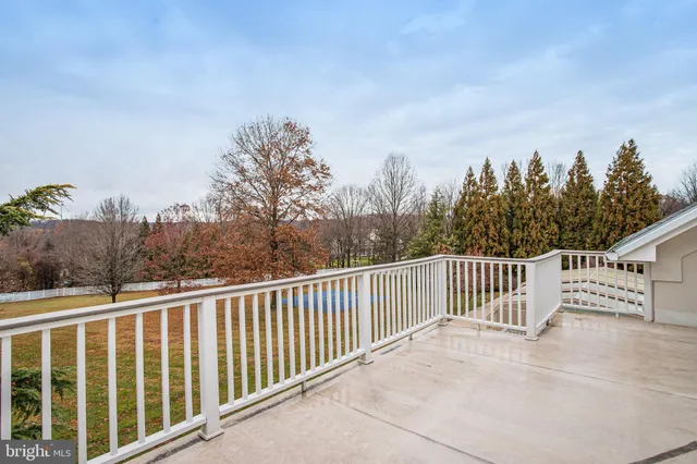 a view of a balcony with trees