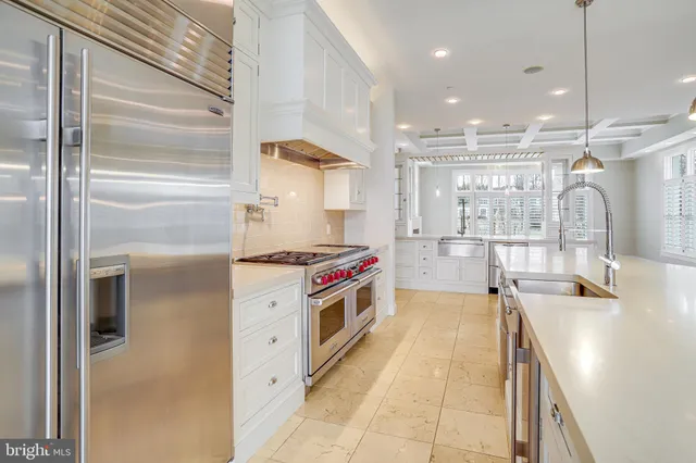 a kitchen with a stove a refrigerator and a sink