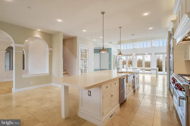 a large kitchen with lots of counter space and glass door