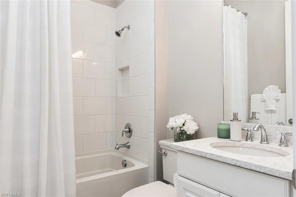 9451 Montelanico Loop Naples, FL 34119 - Photo 11 of 15 a bathroom with a sink vanity granite tub and shower