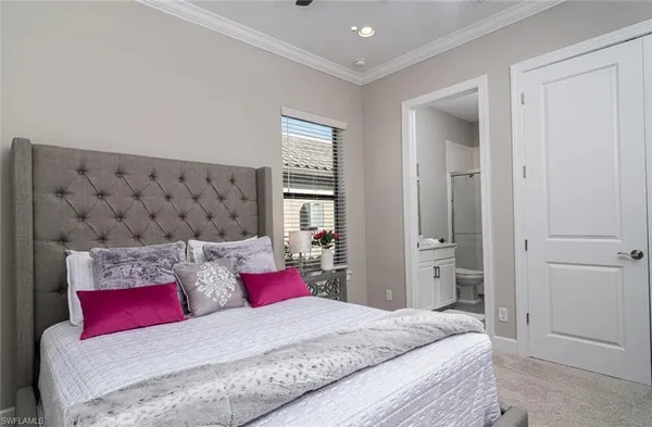 a bedroom with a large bed and a couch