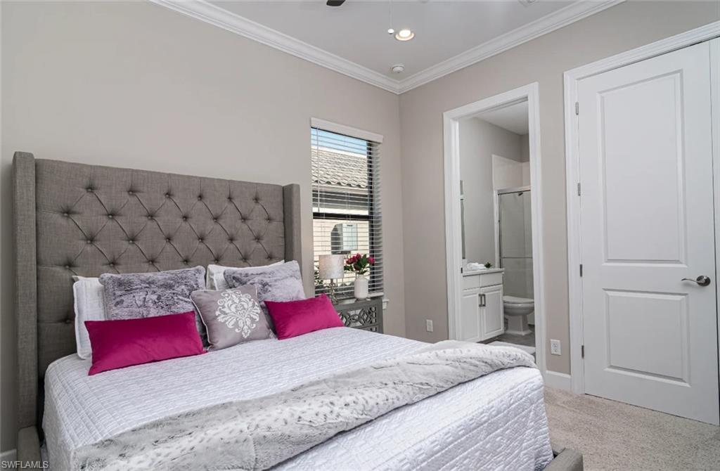 9451 Montelanico Loop Naples, FL 34119 - Photo 12 of 15 a bedroom with a large bed and a couch