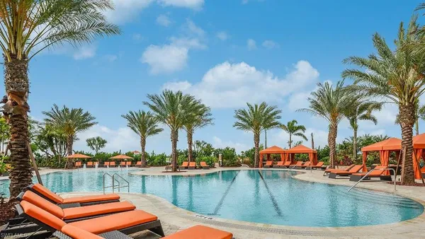 a view of a swimming pool with lounge chairs