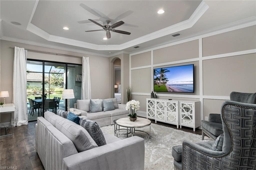 9451 Montelanico Loop Naples, FL 34119 - Photo 4 of 15 a living room with furniture and a flat screen tv