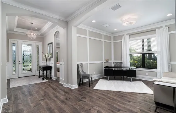 a living room with furniture windows and a table