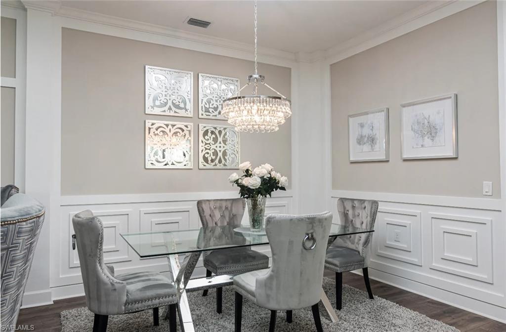 9451 Montelanico Loop Naples, FL 34119 - Photo 7 of 15 a dining room with furniture a chandelier and window