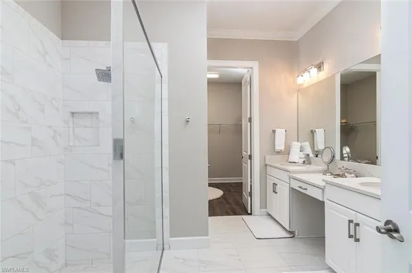a bathroom with a sink a mirror and a shower
