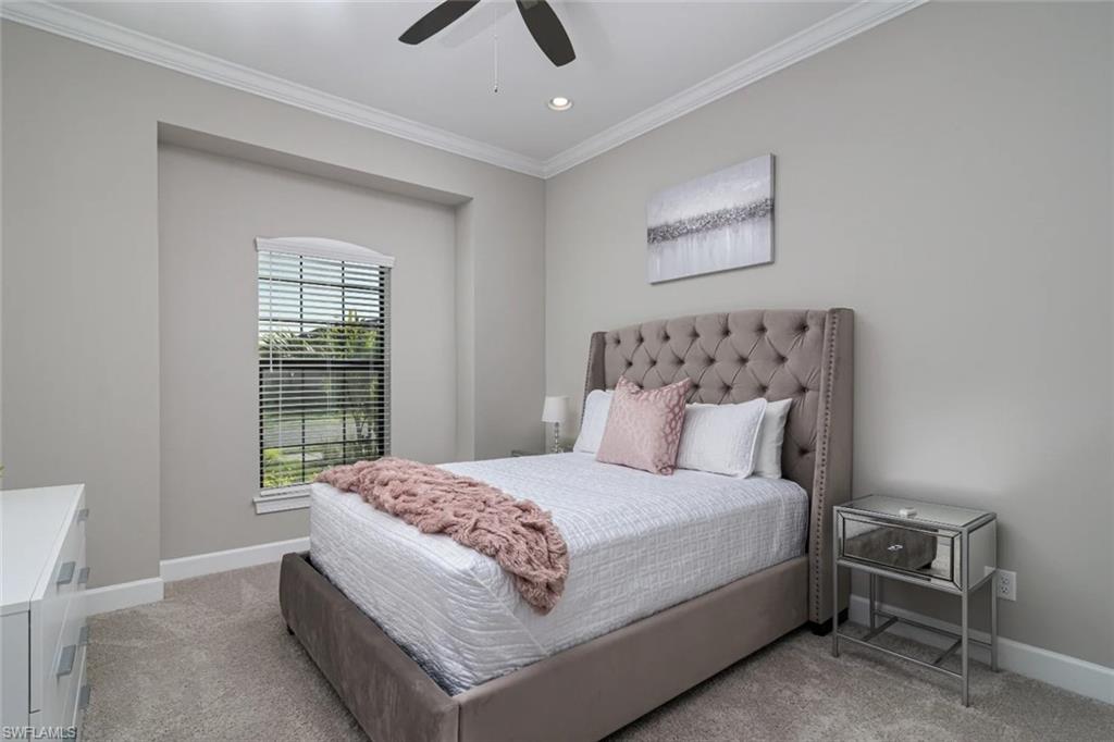 9451 Montelanico Loop Naples, FL 34119 - Photo 10 of 15 a bedroom with a large bed and a window