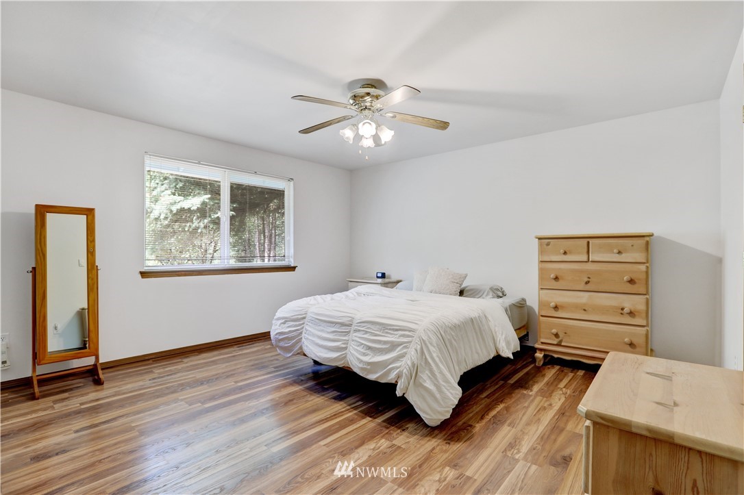 46040 Southeast Edgewick Road North Bend, WA 98045 - Photo 11 of 19 a bedroom with a bed and a chandelier