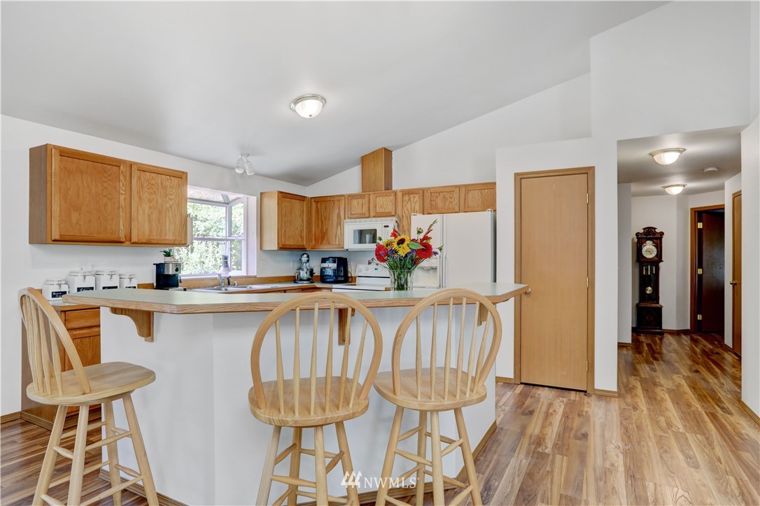 46040 Southeast Edgewick Road North Bend, WA 98045 - Photo 10 of 19 a kitchen with a table chairs sink and cabinets