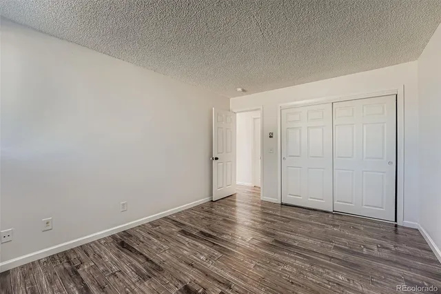 a view of an empty room and wooden floor