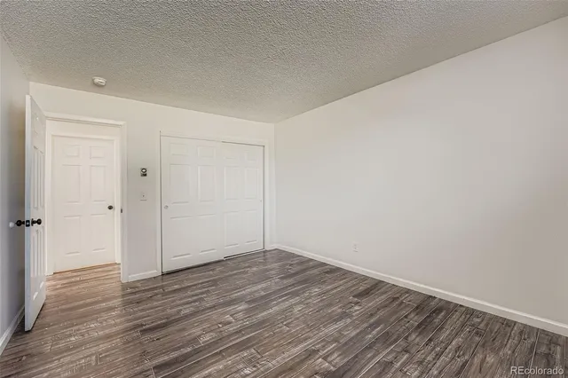 a view of room with wooden floor