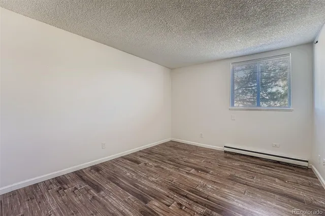 a view of room with wooden floor and window