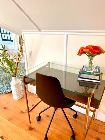 a close view of table chair and wooden floor