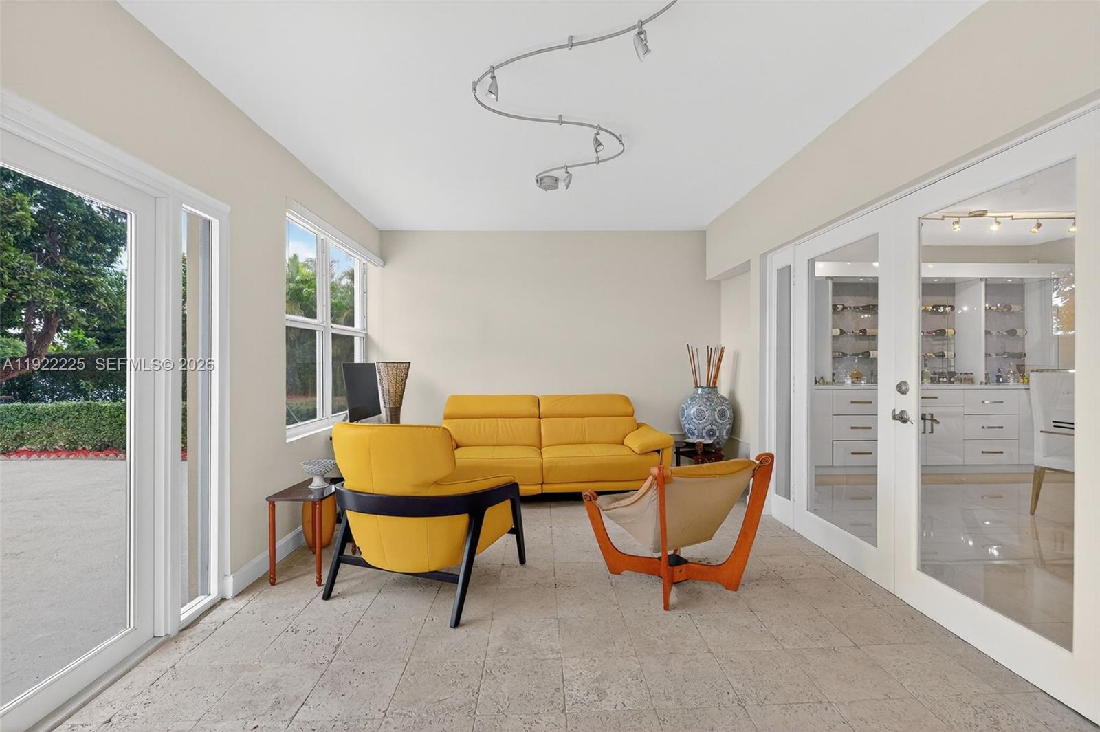9261 Southwest 88th Street Miami, FL 33173 - Photo 18 of 55 a living room with furniture and a floor to ceiling window