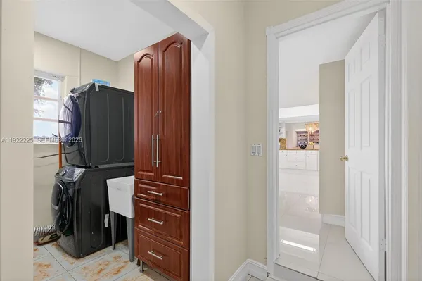 a kitchen with stainless steel appliances kitchen island granite countertop furniture and a refrigerator