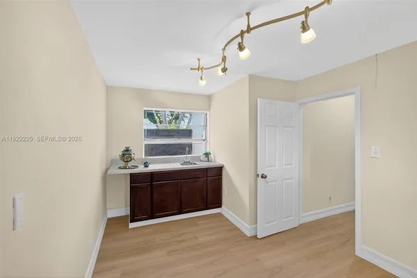 a bedroom with a large bed a flat tv screen and a dresser