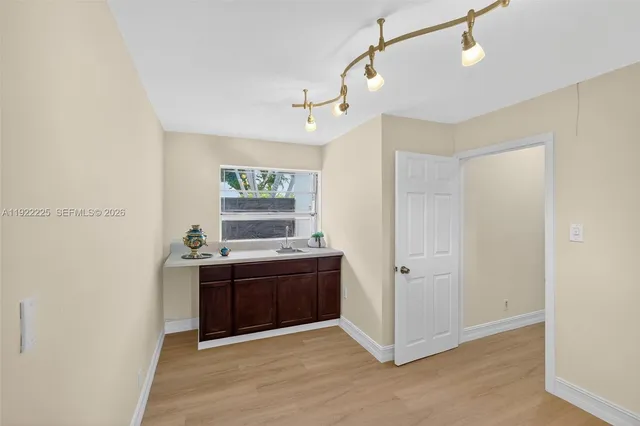 a bedroom with a large bed a flat tv screen and a dresser