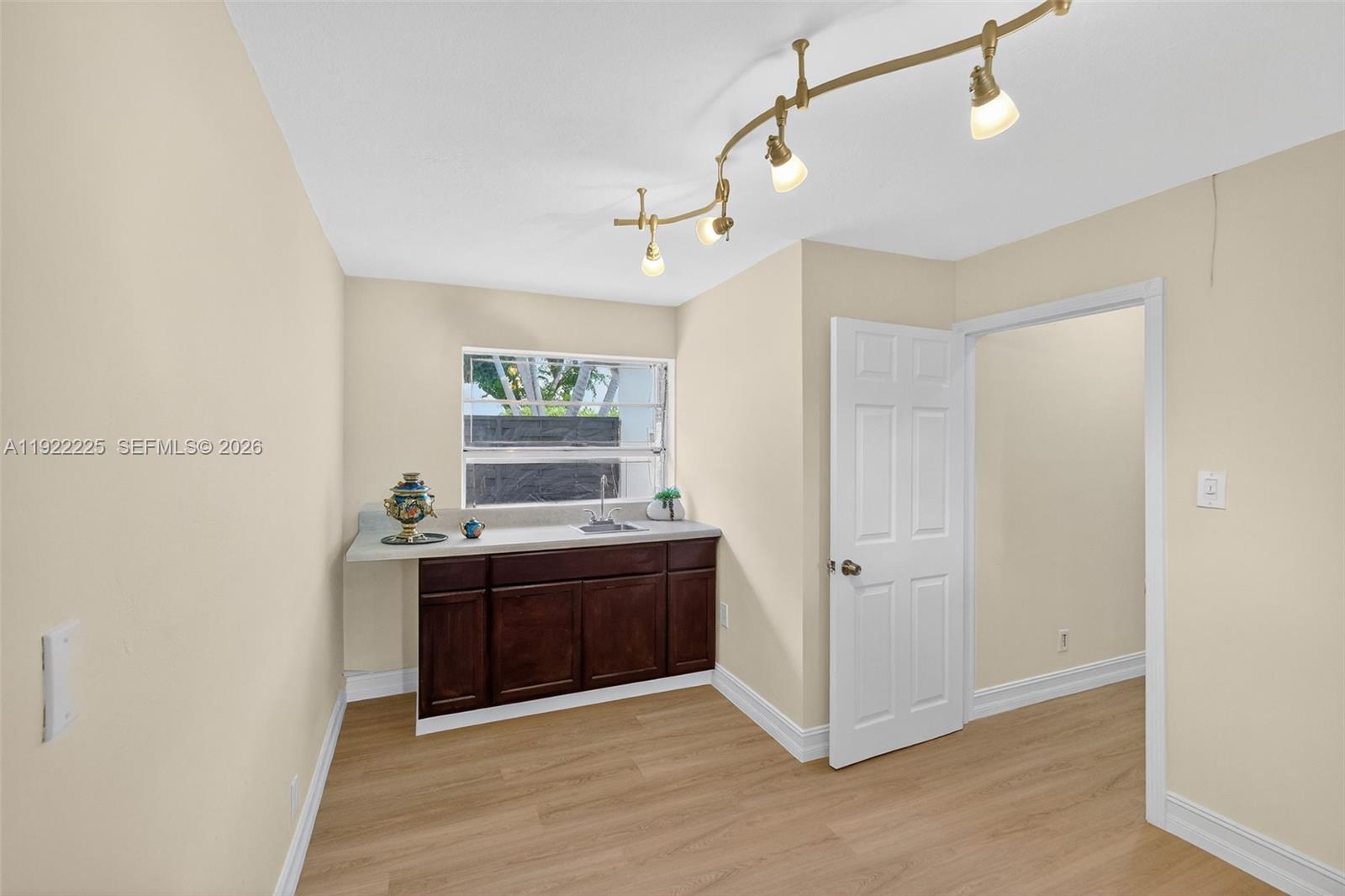 9261 Southwest 88th Street Miami, FL 33173 - Photo 26 of 55 a view of kitchen with wooden floor and window
