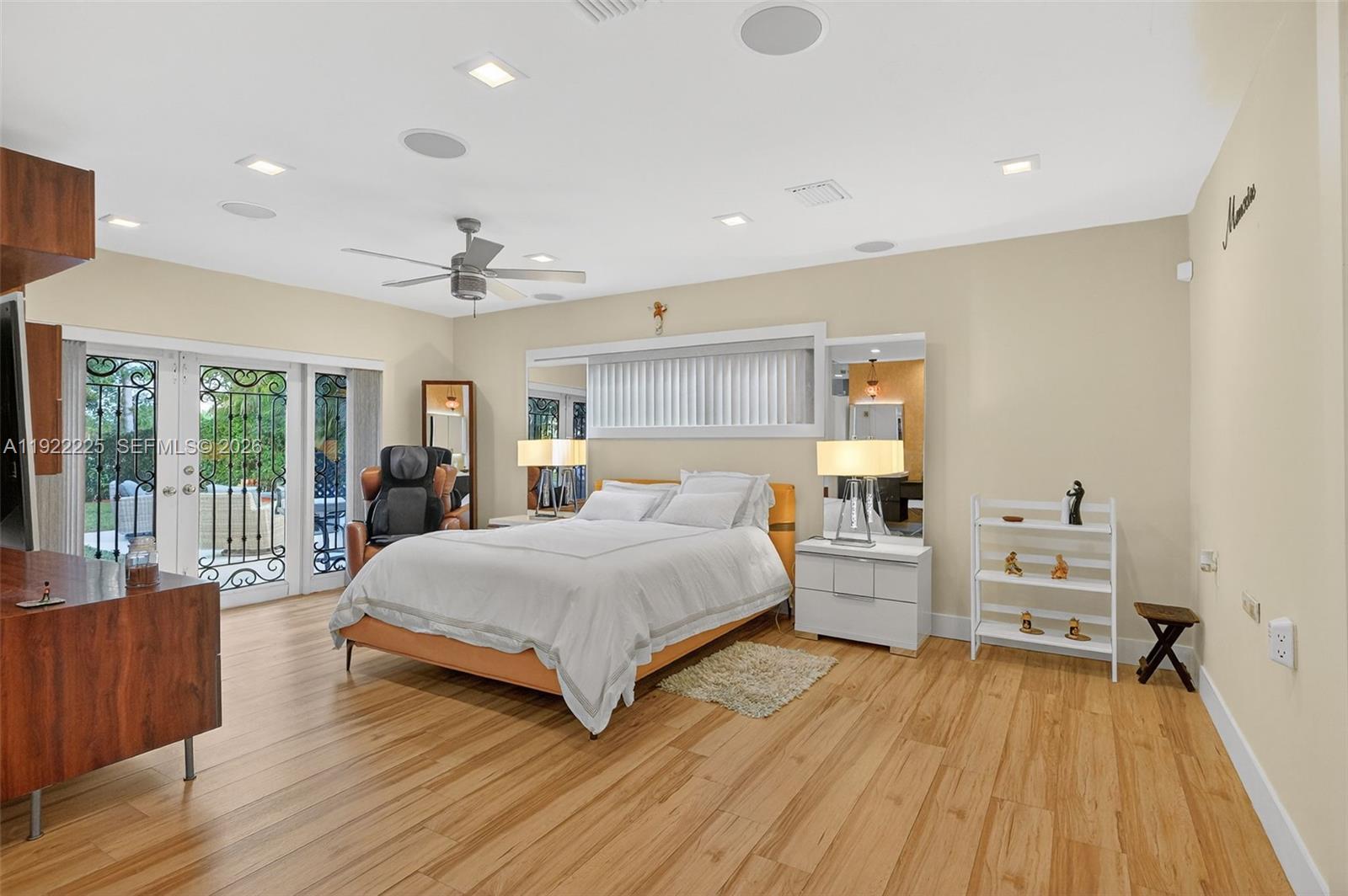 9261 Southwest 88th Street Miami, FL 33173 - Photo 27 of 55 a spacious bedroom with a bed and wooden floor
