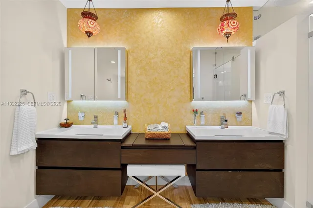 a bathroom with a granite countertop bathtub sink mirror vanity and toilet