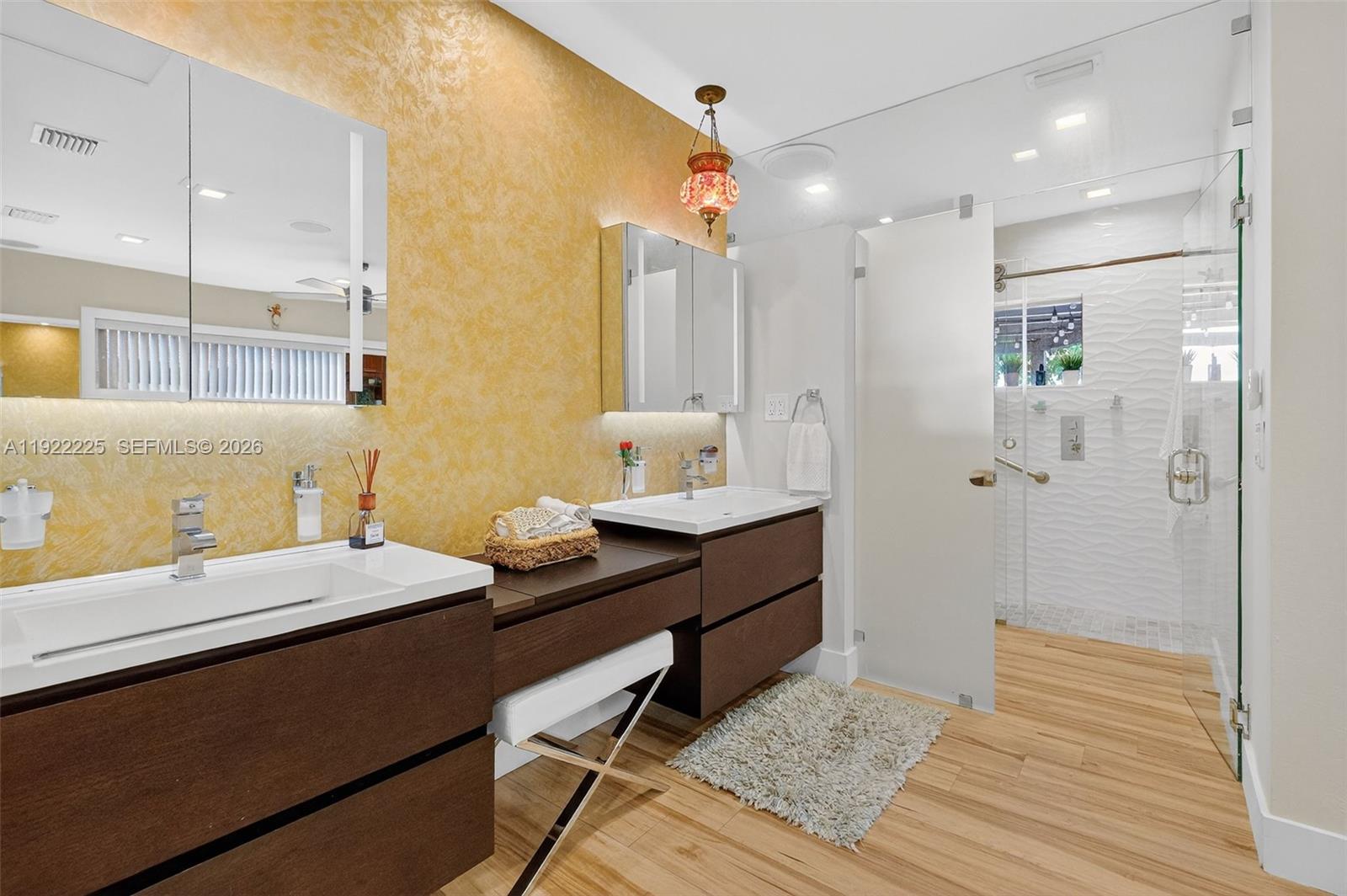 9261 Southwest 88th Street Miami, FL 33173 - Photo 30 of 55 a en suite bathroom with a sink and a mirror