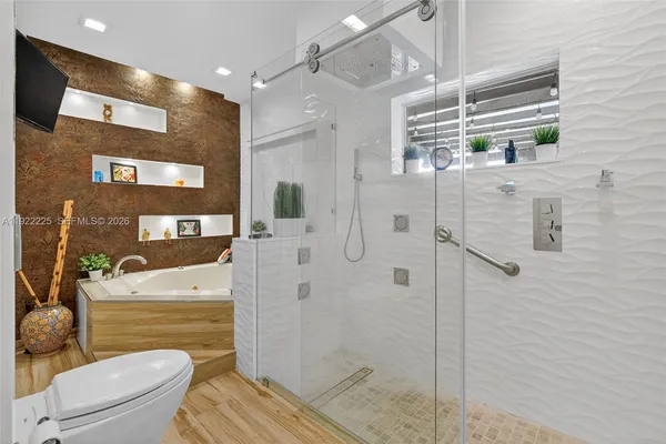 a spacious bathroom with a tub sink and mirror