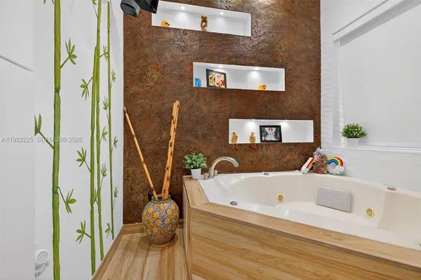 a bed room with a bed a television and a large window