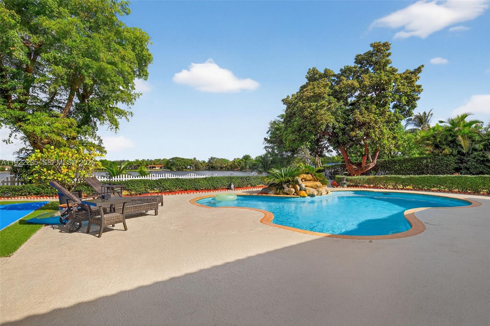 9261 Southwest 88th Street Miami, FL 33173 - Photo 40 of 55 a view of a swimming pool with lounge chair