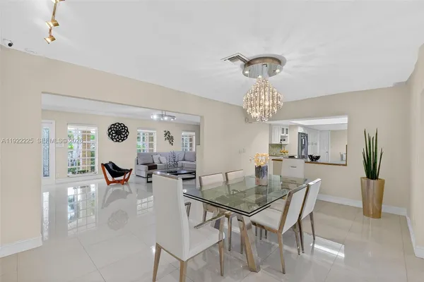 a view of a dining room with furniture and chandelier