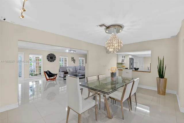 a view of a dining room with furniture and chandelier