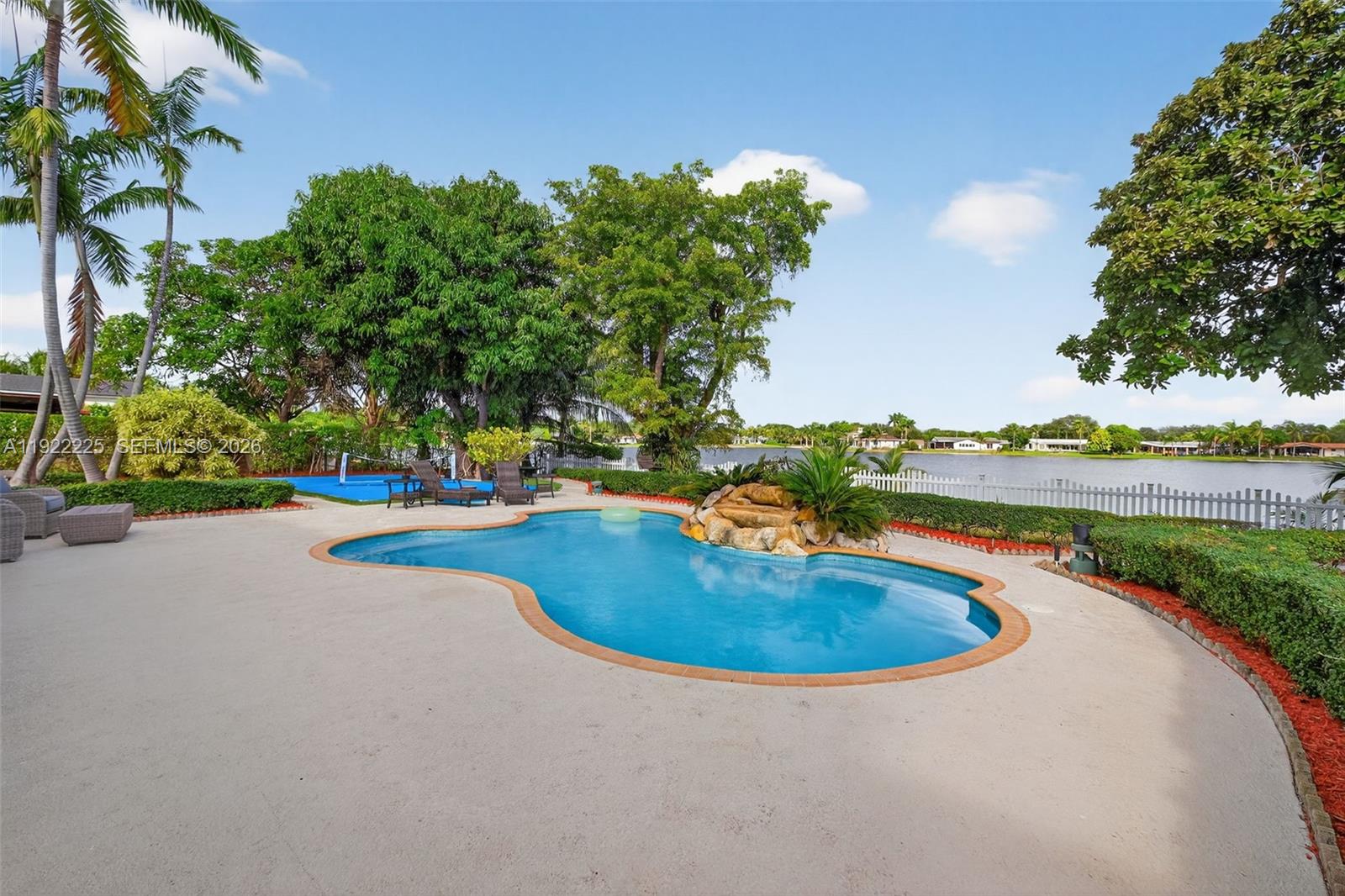 9261 Southwest 88th Street Miami, FL 33173 - Photo 43 of 55 an outdoor view with swimming pool and green space