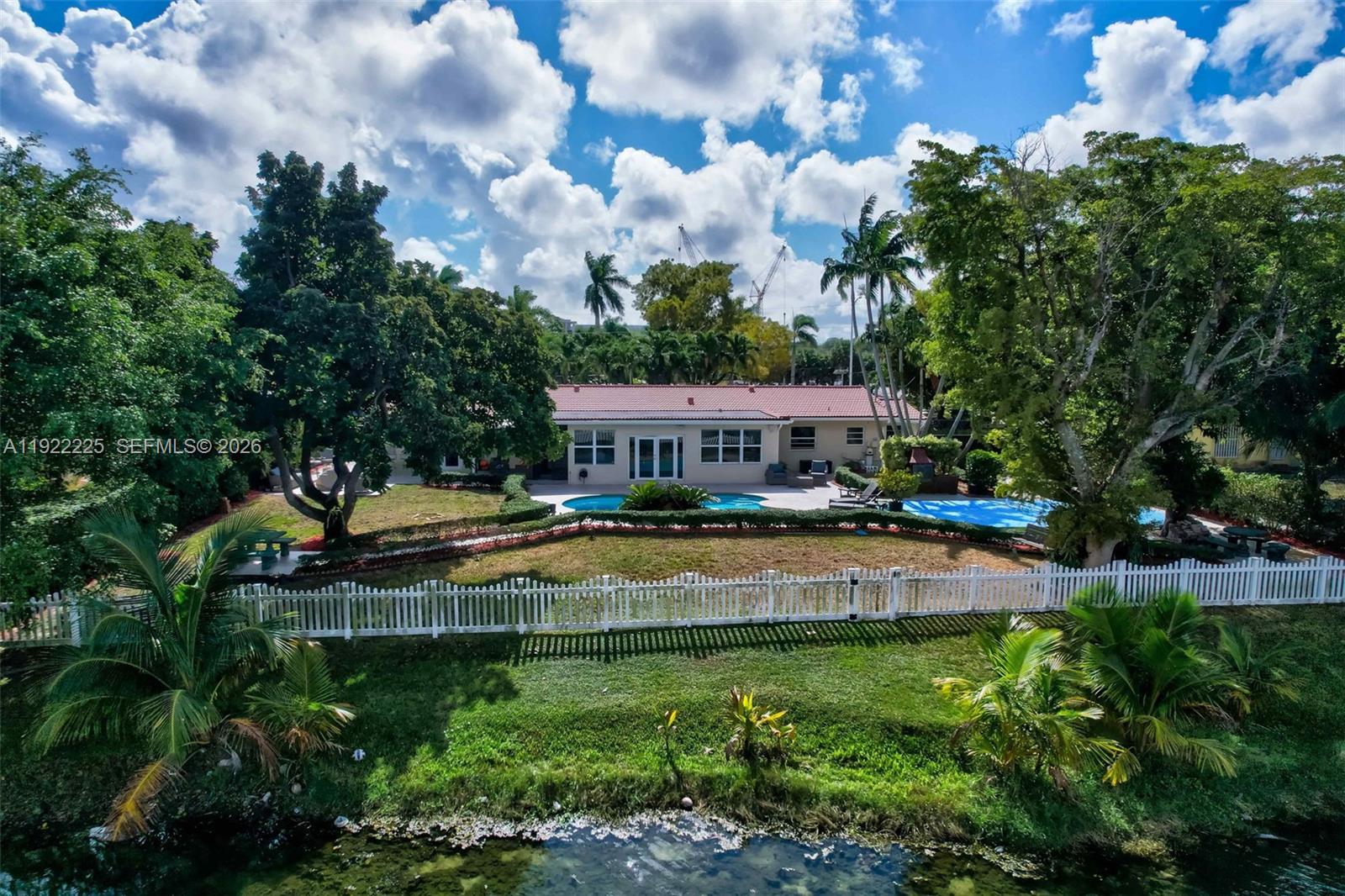 9261 Southwest 88th Street Miami, FL 33173 - Photo 54 of 55 a view of a swimming pool with lawn chairs and plants