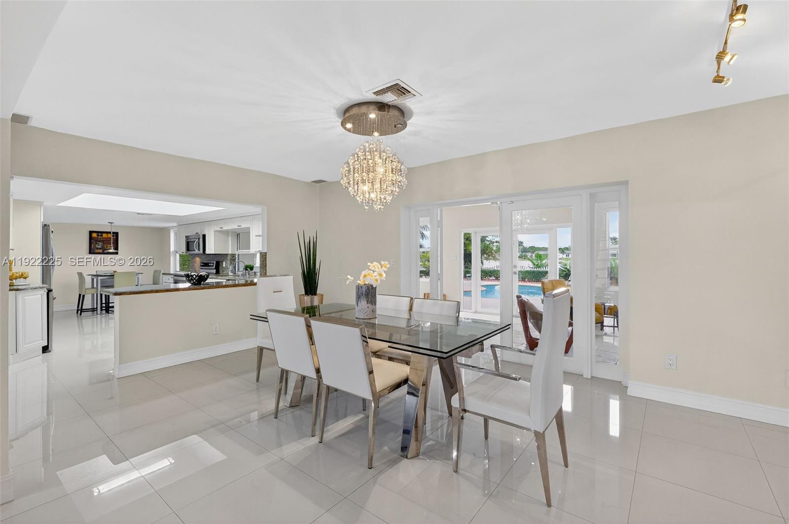 9261 Southwest 88th Street Miami, FL 33173 - Photo 6 of 55 a view of a dining room with furniture and chandelier