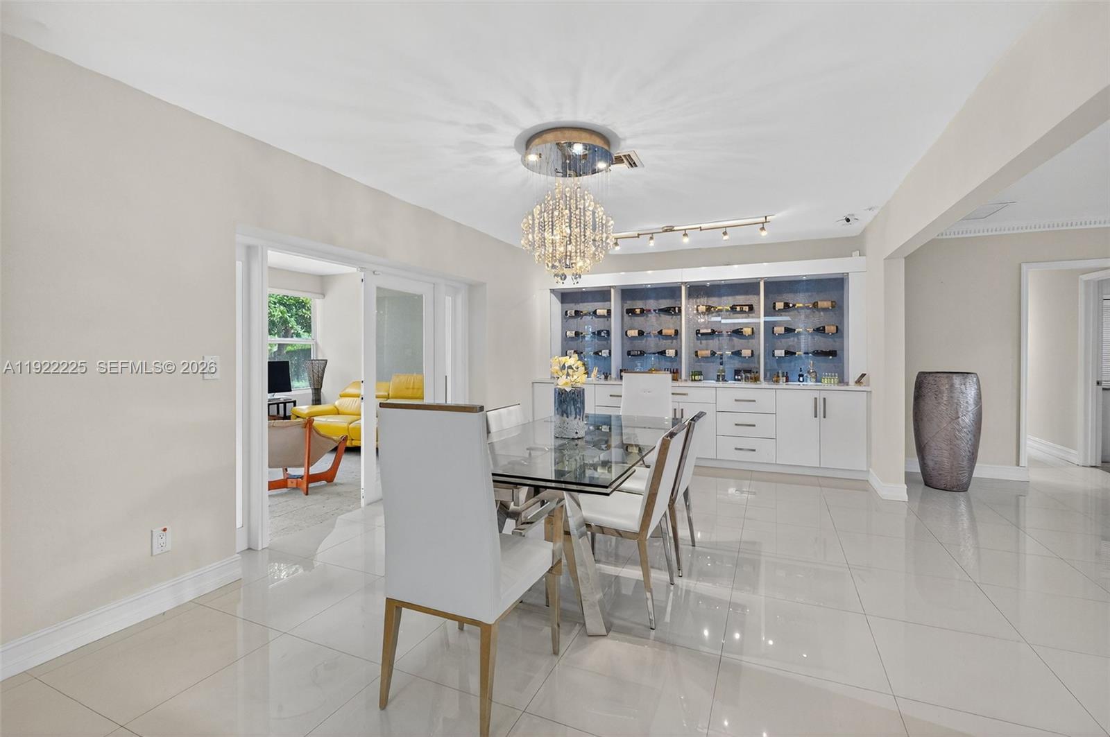 9261 Southwest 88th Street Miami, FL 33173 - Photo 7 of 55 a view of a dining room with furniture and a chandelier