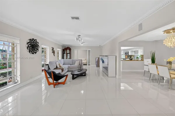 a living room with furniture a rug and a window