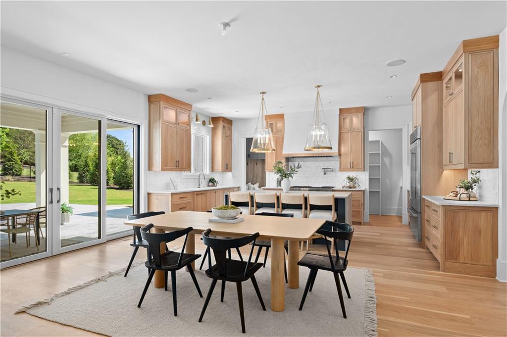10210 Cedar Ridge Drive Milton, GA 30004 - Photo 15 of 47 a view of a dining room with furniture and wooden floor