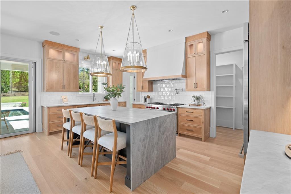 10210 Cedar Ridge Drive Milton, GA 30004 - Photo 17 of 47 a large kitchen with kitchen island a large island in it