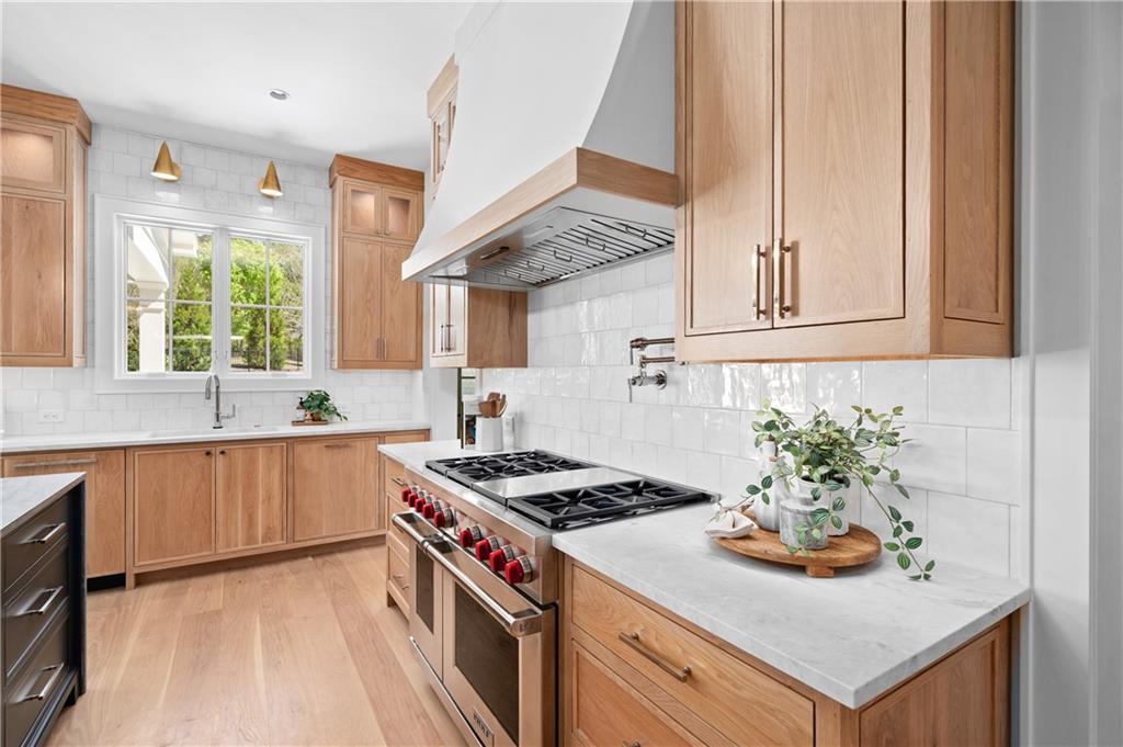 10210 Cedar Ridge Drive Milton, GA 30004 - Photo 19 of 47 a kitchen with stainless steel appliances granite countertop a stove and a sink